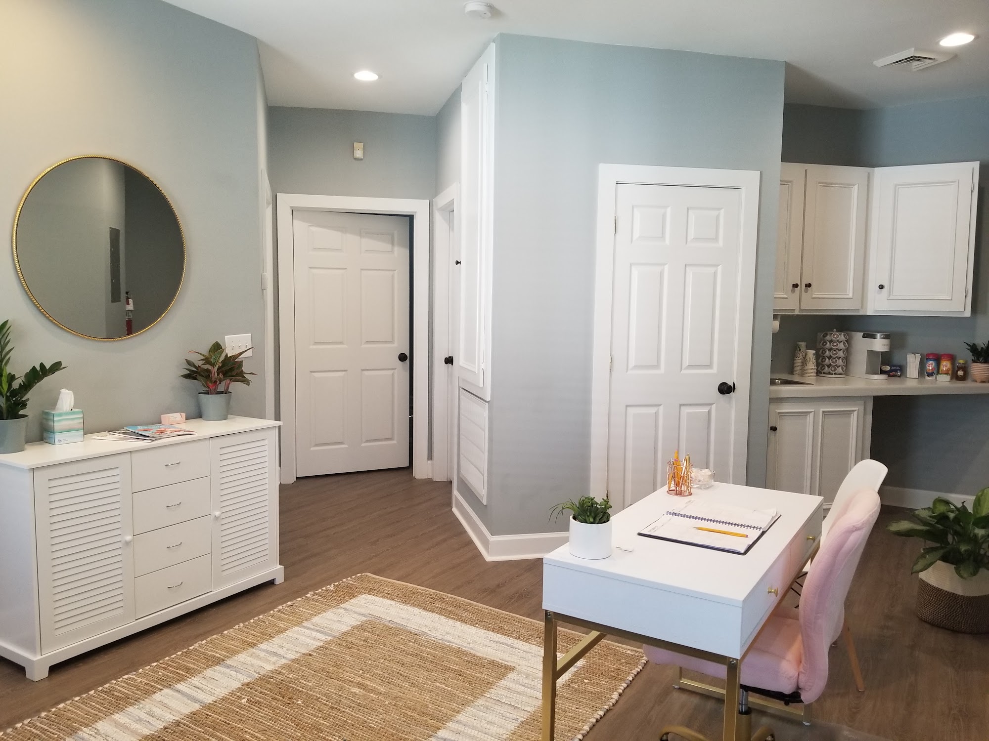 Front room with a desk and kitchenette